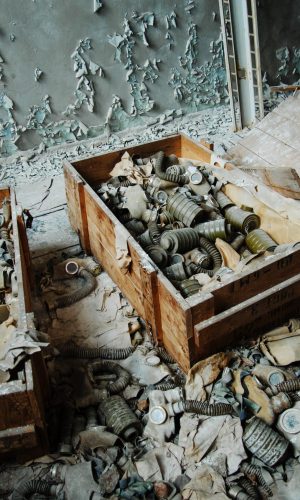 Infected radiation gas masks on the floor at boxes at Chernobyl nuclear power plant zone of alienation.